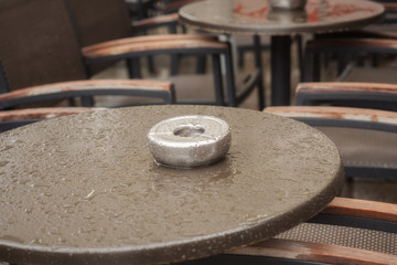 Wet table of a street cafe with ashtray