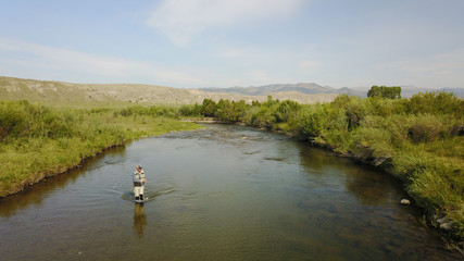 Fototapeta na wymiar Aerial view of fly fisherman fishing in Montana river