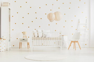 Pastel lanterns above baby's bed