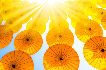 Naklejka premium Sunlight Pattern Yellow umbrellas on blue sky.