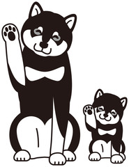 足を振る黒柴犬の親子