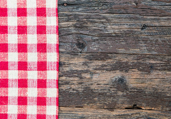 Fototapeta na wymiar White red squares burlap tablecloth texture on black old wooden rustic background. Christmas background