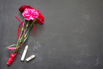 Happy chalk on blackboard with flowers teacher day abstract background
