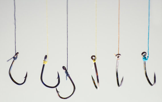 Many fishing hooks hang together.