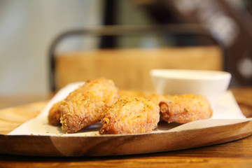 Fried chicken wings on wood background with restaurant light
