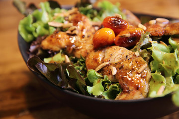 Chicken salad on wood background in restaurant lgiht