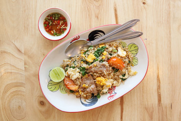 Pork fried rice with lime on wood background , Thai food
