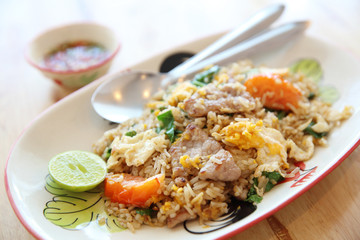 Pork fried rice with lime on wood background , Thai food