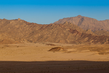 Fototapeta na wymiar Mountain in the desert and the blue sky