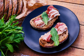 Bread with ham and herbs on a plate.