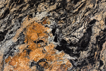 Close up of granite texture, black and brown color, precious stone.