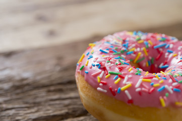 unhealthy but delicious sweet sugar donut cake on vintage wooden table in lifestyle nutrition health care
