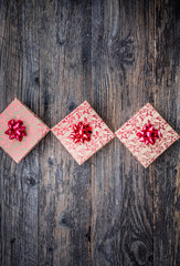 Christmas background with decorations and gift boxes on old rustic black wooden board, top view, copy space