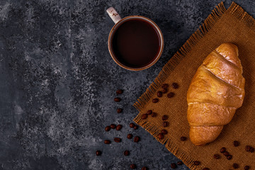 Fresh croissant on dark background.