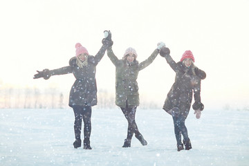 young women walking and having fun in the winter in the snow field