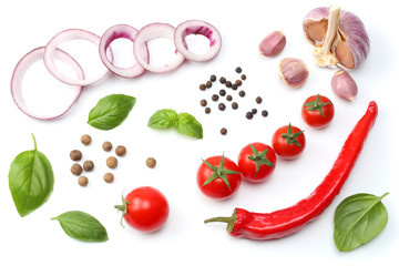 sliced red onion, red hot chili pepper, tomato, garlic and spices isolated on white background. top view