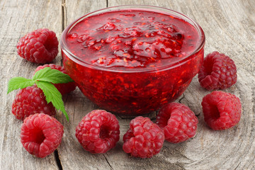 healthy food. raspberry with raspberry jam on old wooden background