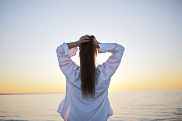 Fototapeta premium Girl at sea view from behind concept freedom rest happiness