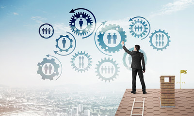 Businessman on house roof presenting teamwork and connection concept. Mixed media