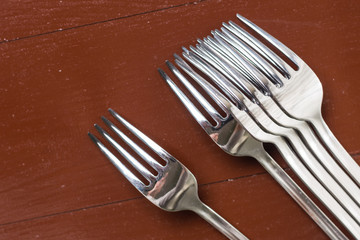 Flat lay above metal forks on the wooden table