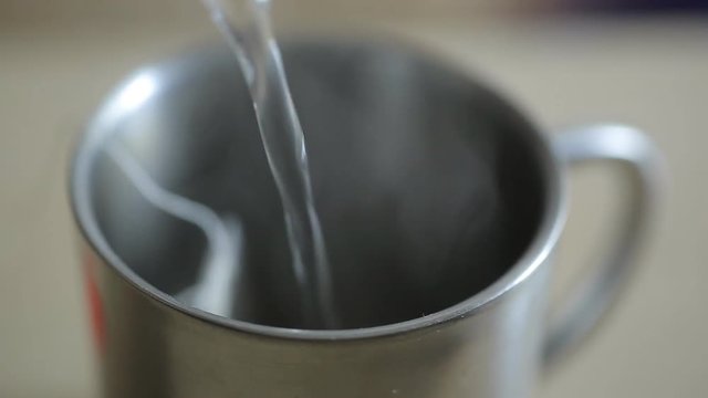 a tea bag is brewed in an iron mug