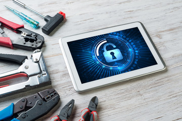 Web security and technology concept with tablet pc on wooden table