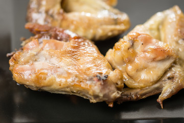 Fried chicken wings served on the black plate