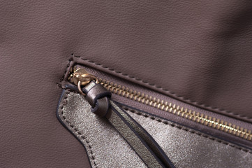 Detail of beige leather bag, golden zipper