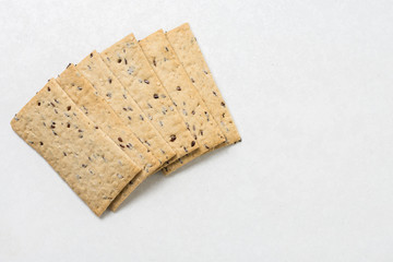 Flax chips isolated above white marble background table