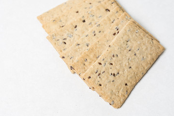 Flax chips isolated above white marble background table