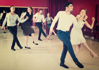Young people dancing rock-and-roll in pairs