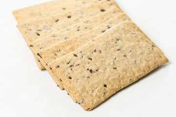 Flax chips isolated above white marble background table