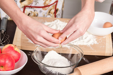 Hands break chicken eggs