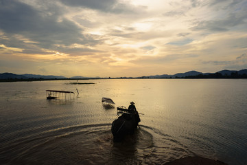 Vietnam landscape. Lake with elephant walking at sunset in Vietnam