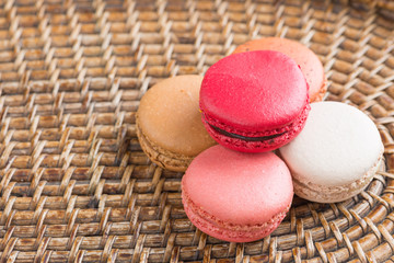 Colorful macaroons. Sweet macarons on wood  background .
