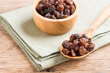 Raisins on a wood background.