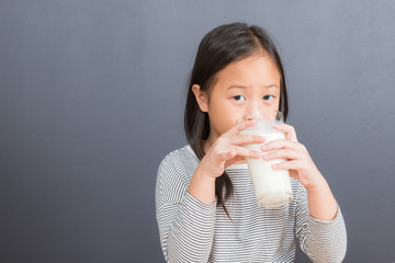 Asian kid cute girl  happy to drink milk