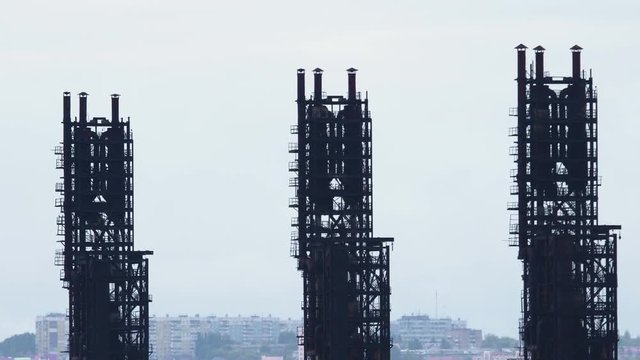 Long shot of oil refinery units in sunny weather with clouds in background. Gas industry background.