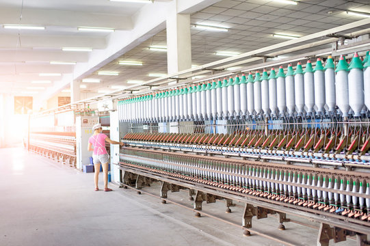 The women workers in the textile factory are at work