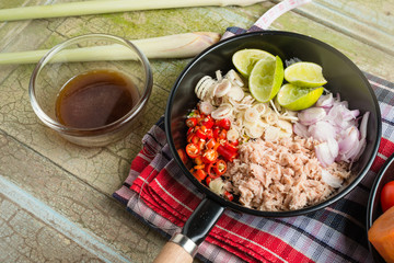 Spicy tuna salad on wood background