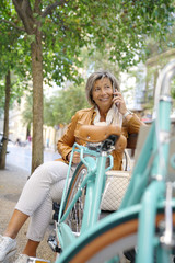 Senior woman using bike on shopping day