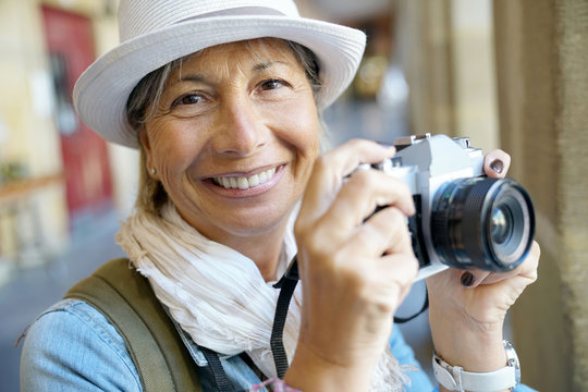 Senior woman taking pictures on tourist journey