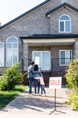 family looking at house on sale