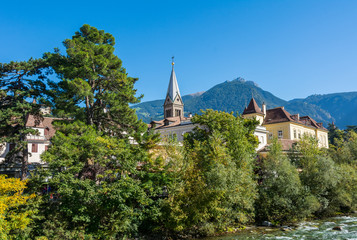 Fototapeta premium Merano in South Tyrol, a beautiful city of Trentino Alto Adige, View on the famous promenade along the Passirio river. Italy.