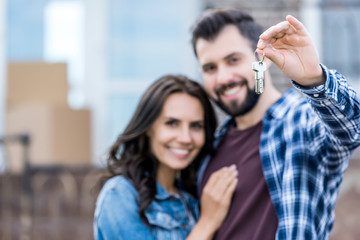 couple with keys of new house