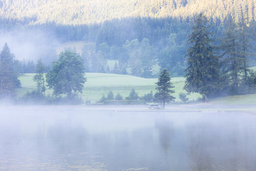 Lake at foggy morning misty weather