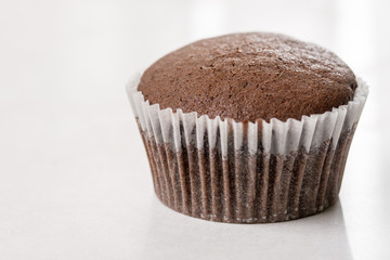Chocolate cup cake on the white marble background with copy space