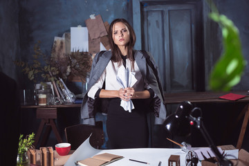 Young business woman throwing documents at camera.