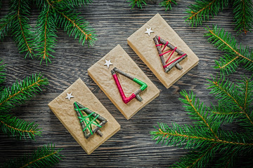 Fir branch gift boxes on wooden board