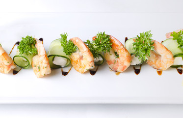 Appetizer of shrimps with Philadelphia cheese on a white plate